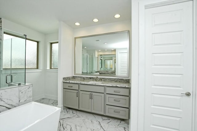 bathroom featuring shower with separate bathtub and vanity