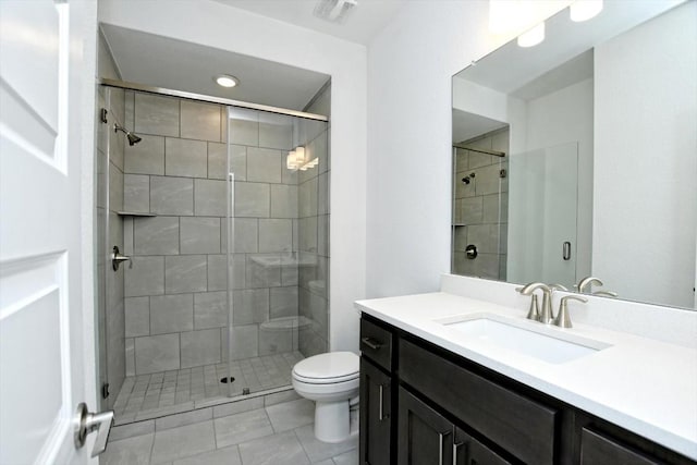 bathroom with walk in shower, vanity, toilet, and tile patterned flooring