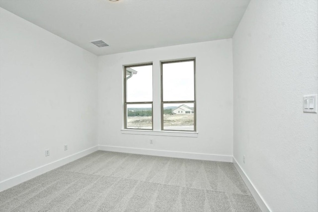 unfurnished room featuring light colored carpet