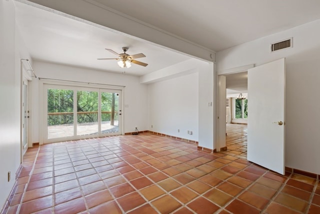 tiled spare room with ceiling fan