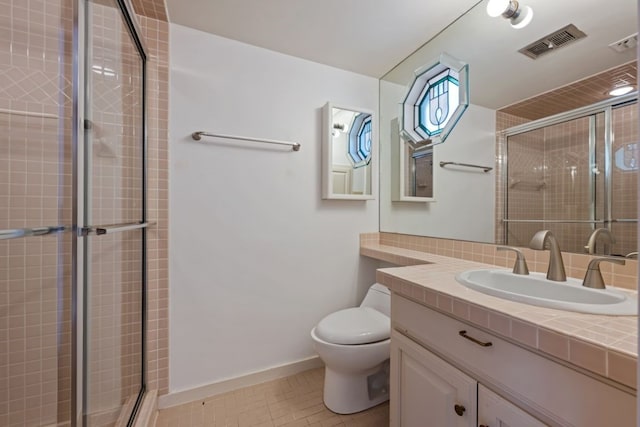 bathroom with walk in shower, tile patterned flooring, vanity, and toilet