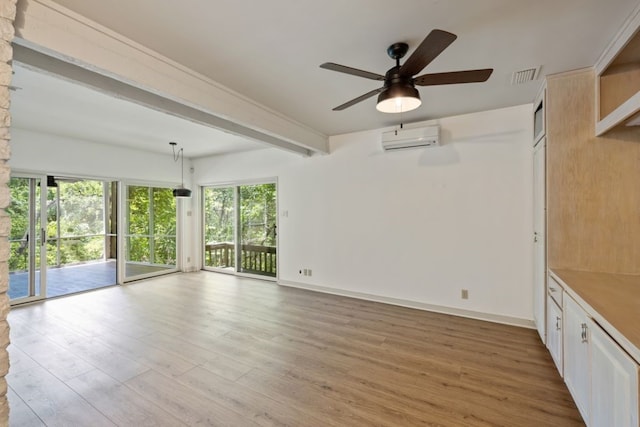 interior space featuring beamed ceiling, wood-type flooring, a wall mounted AC, and ceiling fan