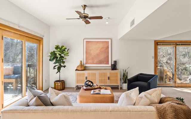 living room with ceiling fan and light carpet