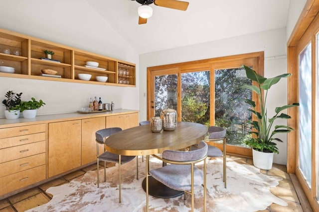 dining area featuring ceiling fan and vaulted ceiling