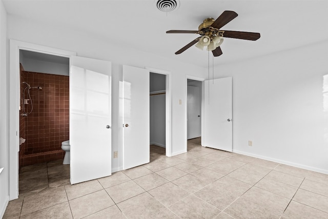 unfurnished bedroom featuring light tile patterned floors, connected bathroom, a closet, and ceiling fan