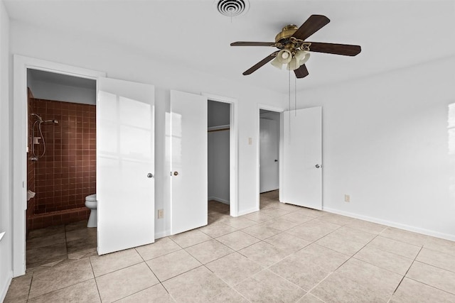 8507 Contour Dr, Austin, TX 78757 - unfurnished bedroom featuring light tile patterned flooring, a closet, ensuite bathroom, and a ceiling fan