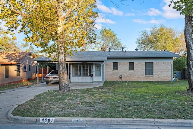 8507 Contour Dr, Austin, TX 78757 - ranch-style home featuring a front yard, driveway, brick siding, and a carport