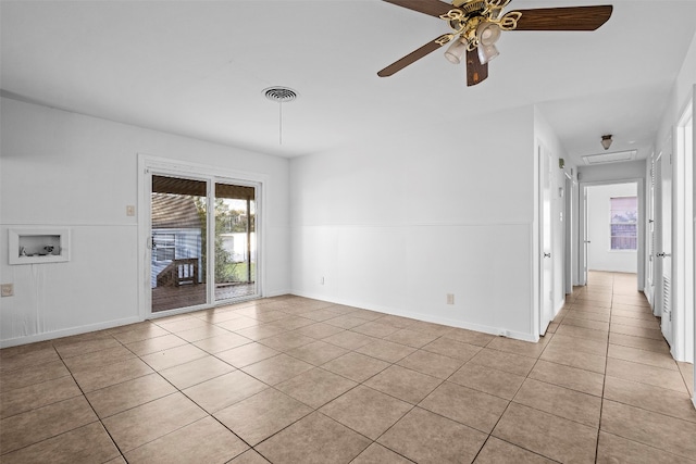 tiled empty room featuring ceiling fan