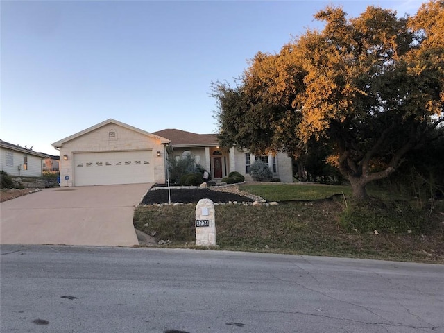 3704 Bunyan Cir, Lago Vista, TX 78645 - ranch-style home featuring concrete driveway, an attached garage, and a front yard