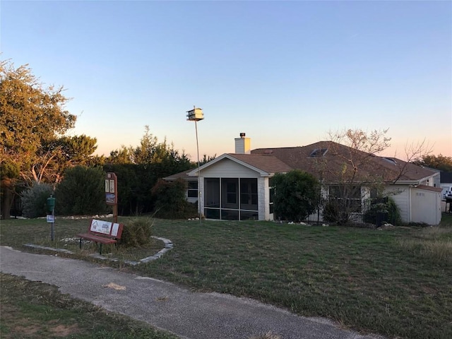 3704 Bunyan Cir, Lago Vista, TX 78645 - ranch-style home featuring a sunroom, a lawn, and a chimney