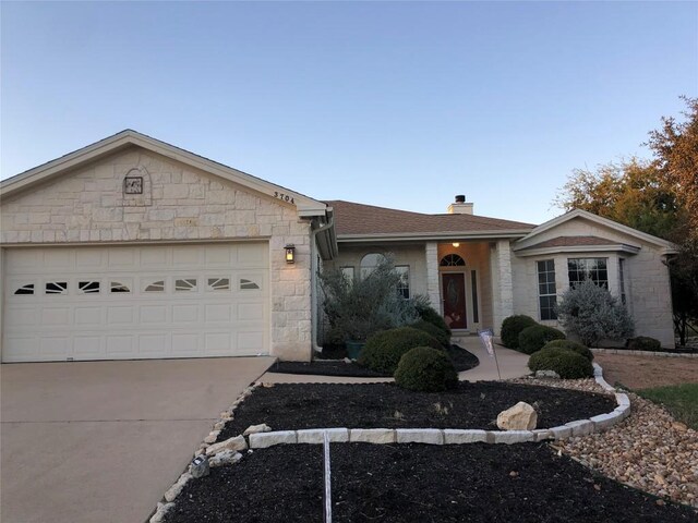 3704 Bunyan Cir, Lago Vista, TX 78645 - ranch-style house with stone siding, concrete driveway, a chimney, a garage, and a shingled roof