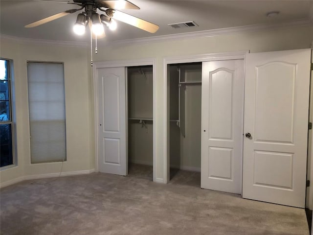 3704 Bunyan Cir, Lago Vista, TX 78645 - unfurnished bedroom with carpet, multiple closets, ornamental molding, and ceiling fan