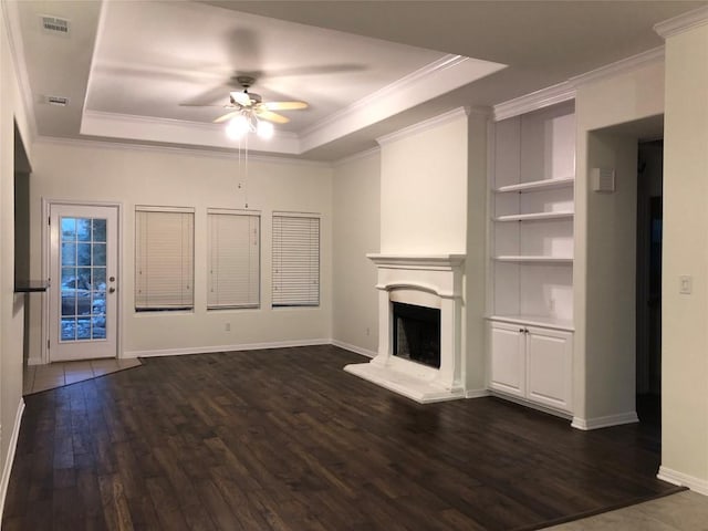 3704 Bunyan Cir, Lago Vista, TX 78645 - unfurnished living room with a raised ceiling, ceiling fan, dark wood-style floors, and ornamental molding
