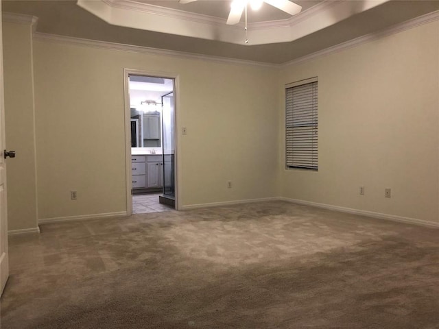 3704 Bunyan Cir, Lago Vista, TX 78645 - empty room featuring a tray ceiling, carpet floors, ornamental molding, and ceiling fan