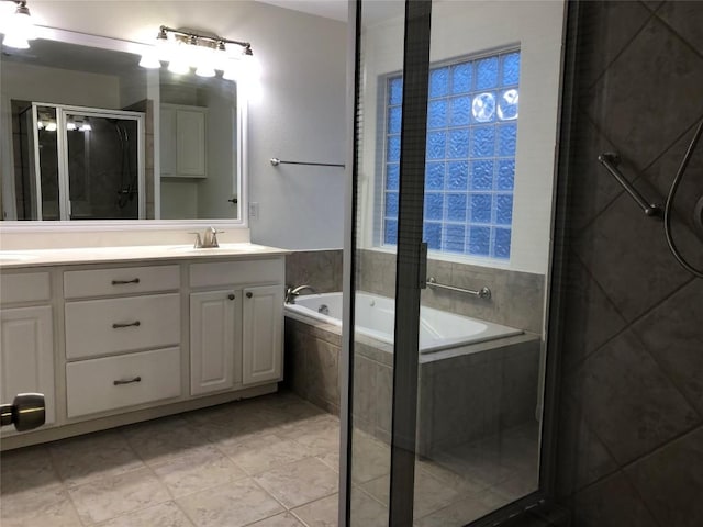 3704 Bunyan Cir, Lago Vista, TX 78645 - bathroom with a garden tub, a stall shower, double vanity, and tile patterned floors