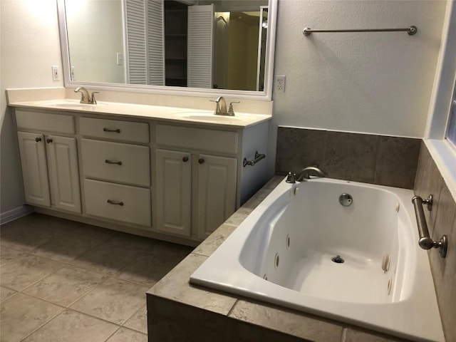 3704 Bunyan Cir, Lago Vista, TX 78645 - bathroom featuring double vanity, a tub with jets, and tile patterned flooring