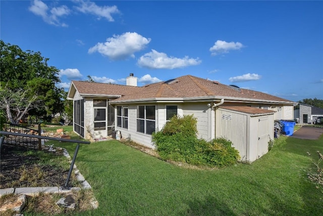 3704 Bunyan Cir, Lago Vista, TX 78645 - rear view of house with a sunroom, a lawn, a chimney, and a shingled roof