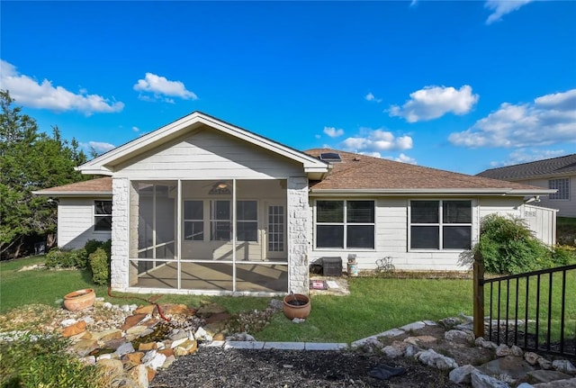 3704 Bunyan Cir, Lago Vista, TX 78645 - rear view of property with a sunroom, a yard, and a shingled roof