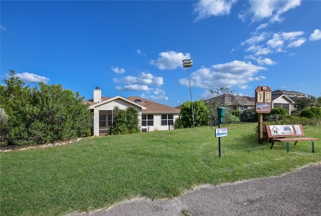 3704 Bunyan Cir, Lago Vista, TX 78645 - view of front of home with a front yard and a chimney