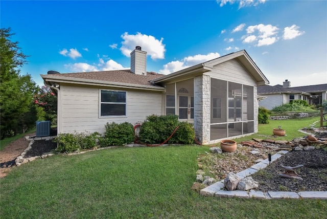 3704 Bunyan Cir, Lago Vista, TX 78645 - back of house featuring a chimney, a sunroom, a lawn, and roof with shingles