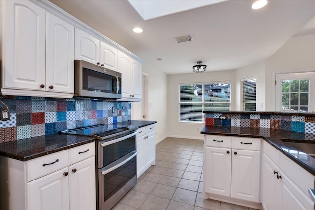 3704 Bunyan Cir, Lago Vista, TX 78645 - kitchen with stainless steel appliances, decorative backsplash, white cabinetry, light tile patterned floors, and recessed lighting