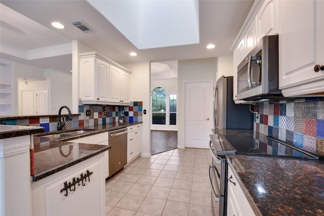 3704 Bunyan Cir, Lago Vista, TX 78645 - kitchen featuring appliances with stainless steel finishes, white cabinetry, decorative backsplash, recessed lighting, and dark stone countertops