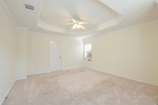 3704 Bunyan Cir, Lago Vista, TX 78645 - spare room with a tray ceiling, ceiling fan, ornamental molding, and light colored carpet