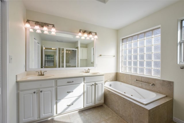 3704 Bunyan Cir, Lago Vista, TX 78645 - full bathroom featuring a stall shower, a tub with jets, double vanity, and healthy amount of natural light