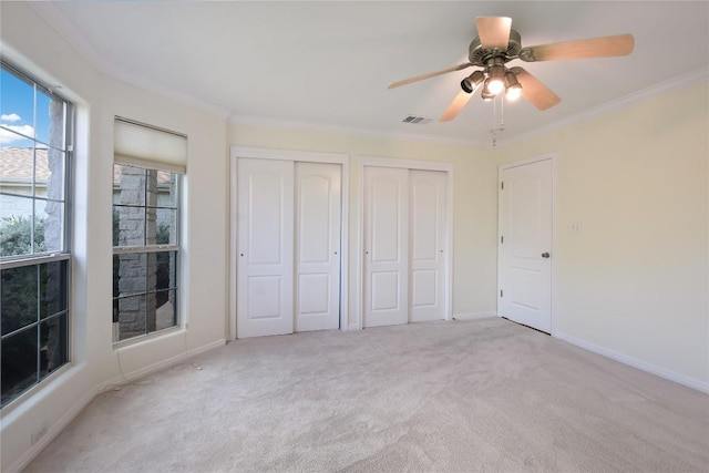3704 Bunyan Cir, Lago Vista, TX 78645 - unfurnished bedroom featuring two closets, carpet, crown molding, and a ceiling fan