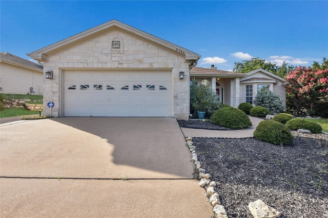 3704 Bunyan Cir, Lago Vista, TX 78645 - single story home featuring stone siding, concrete driveway, and a garage