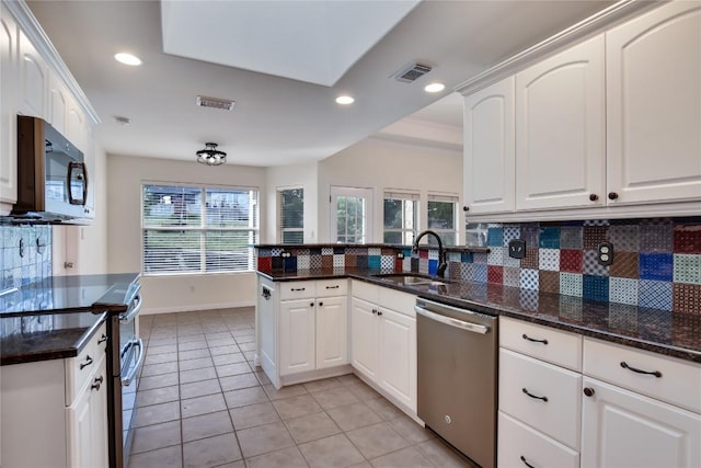 3704 Bunyan Cir, Lago Vista, TX 78645 - kitchen with stainless steel appliances, backsplash, light tile patterned floors, white cabinets, and recessed lighting