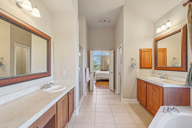 bathroom with tile patterned flooring, vanity, and separate shower and tub