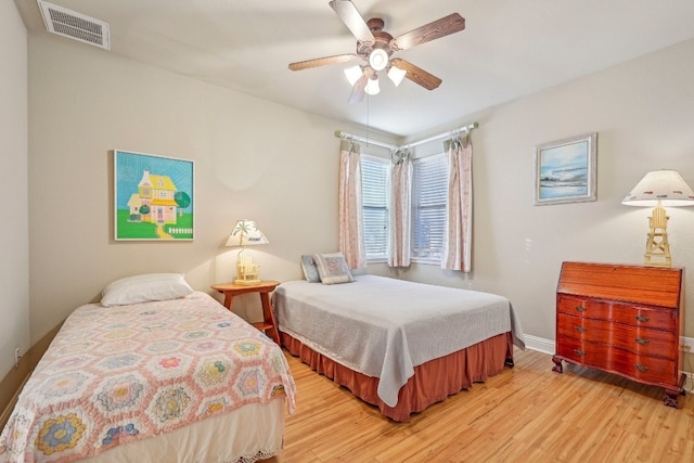 bedroom with light hardwood / wood-style floors and ceiling fan