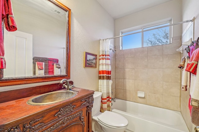 full bathroom featuring shower / bath combo, vanity, and toilet