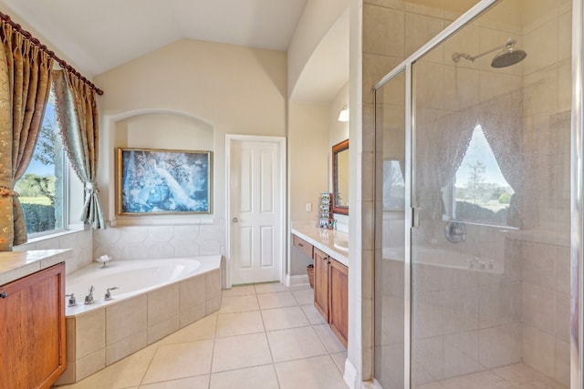 bathroom featuring tile patterned flooring, vanity, independent shower and bath, and lofted ceiling