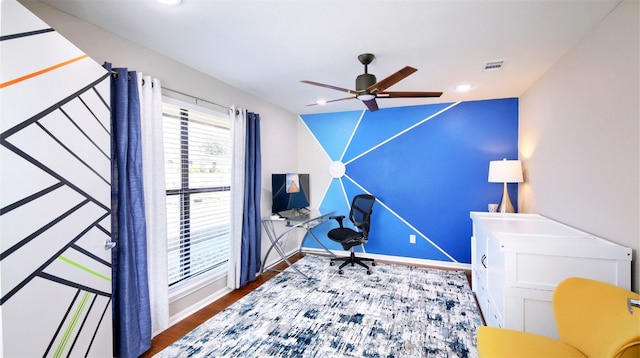 home office with ceiling fan and hardwood / wood-style floors