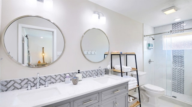 bathroom featuring vanity, toilet, and a shower with door