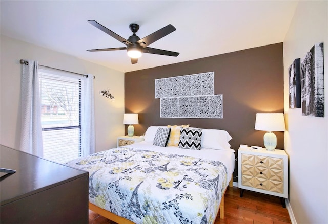 bedroom with ceiling fan and dark hardwood / wood-style floors