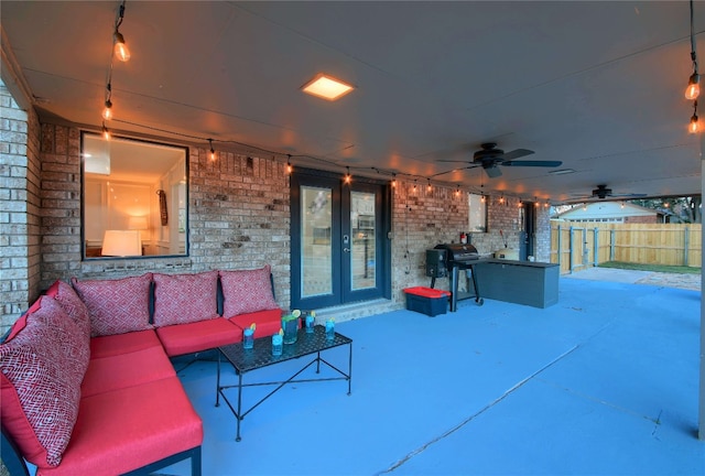 view of patio / terrace with french doors, an outdoor living space, and grilling area