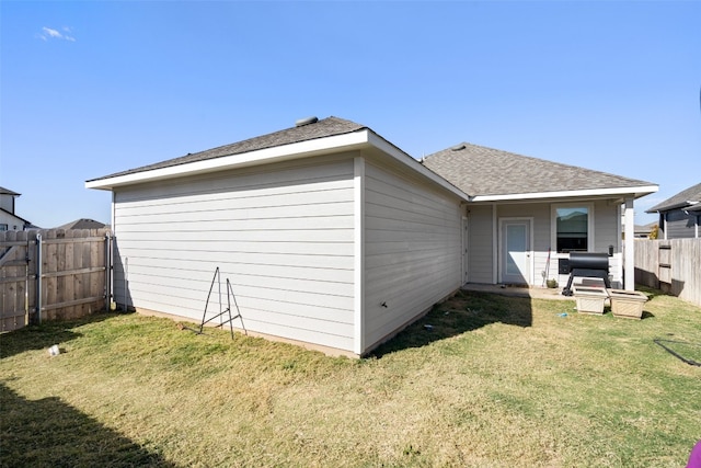 rear view of house with a lawn