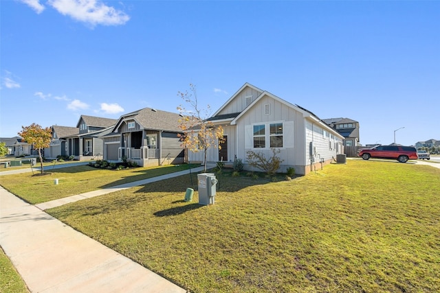 view of front facade with a front yard and central AC