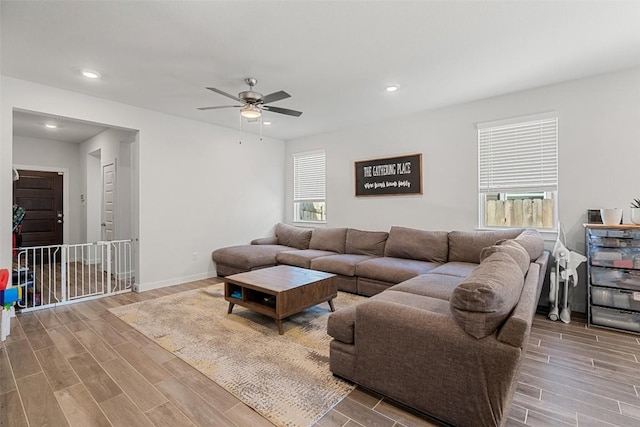 living room featuring recessed lighting, baseboards, and wood tiled floor