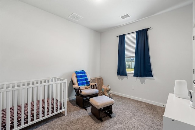 carpeted bedroom featuring a crib, baseboards, and visible vents