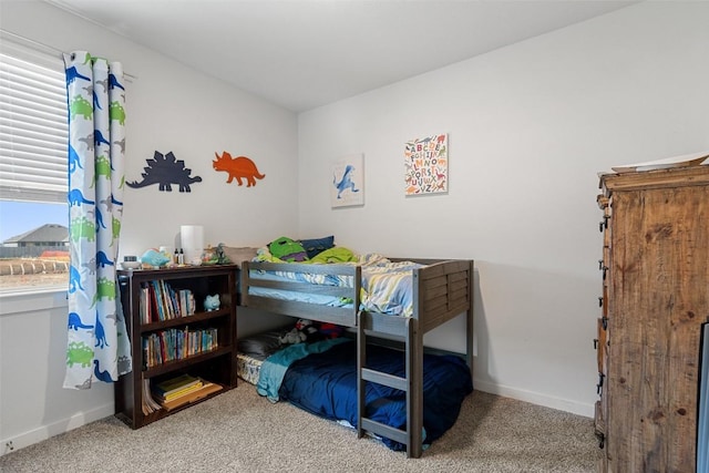 carpeted bedroom with multiple windows and baseboards