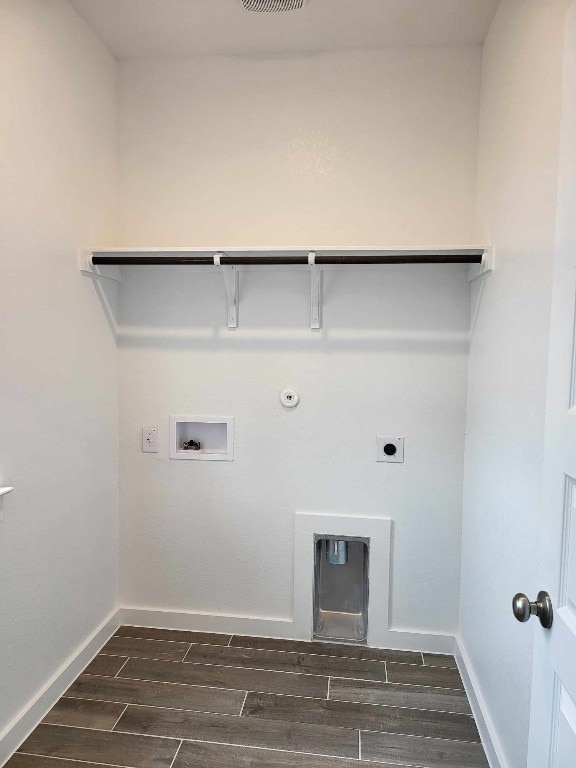 washroom with baseboards, gas dryer hookup, wood finish floors, laundry area, and electric dryer hookup