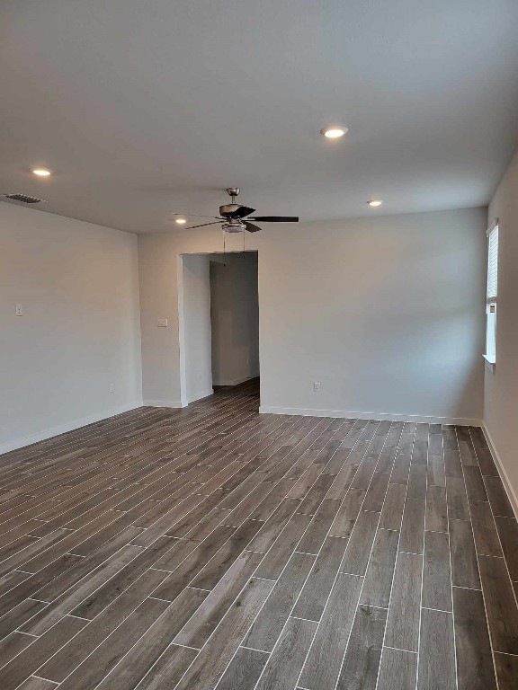 empty room with a ceiling fan, recessed lighting, wood finished floors, and visible vents