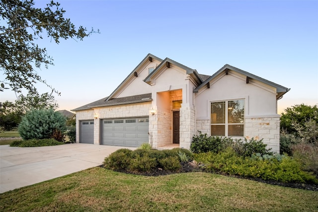 view of front of home featuring a lawn and a garage