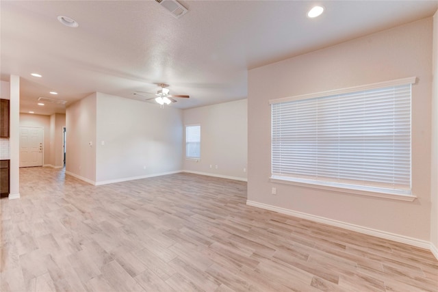 empty room featuring ceiling fan and light hardwood / wood-style floors