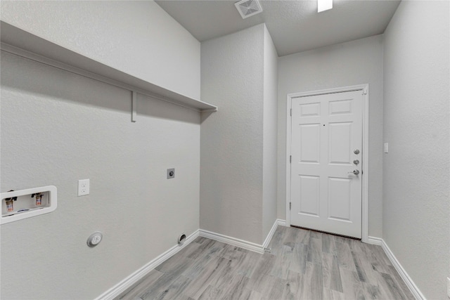 washroom with hookup for a washing machine, light wood-type flooring, and electric dryer hookup