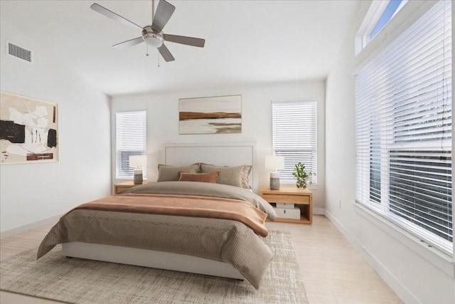 bedroom with light hardwood / wood-style flooring and ceiling fan